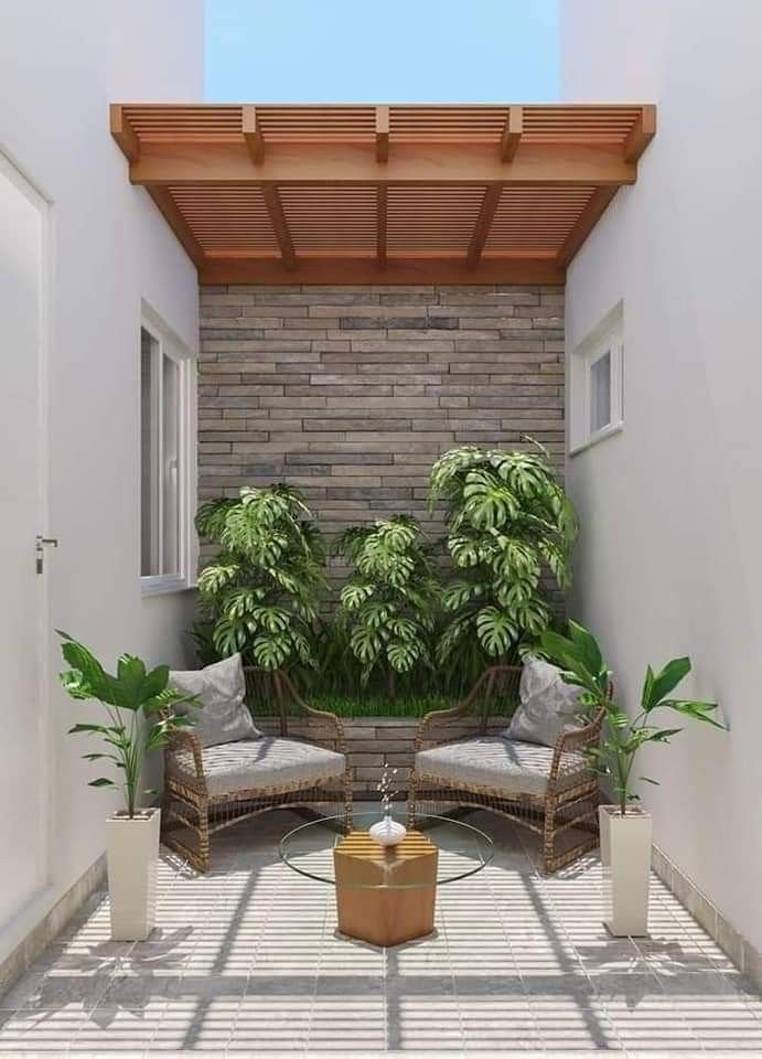 Diseño de patio con sillas de mimbre y pérgola